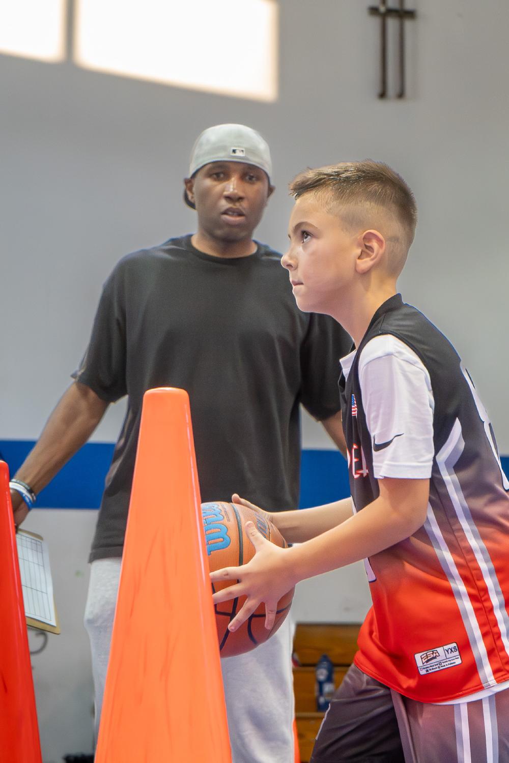 Young basketball player practicing fundamental skills in Orange County gym