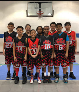 youth basketball team lined up for a photo in a gym